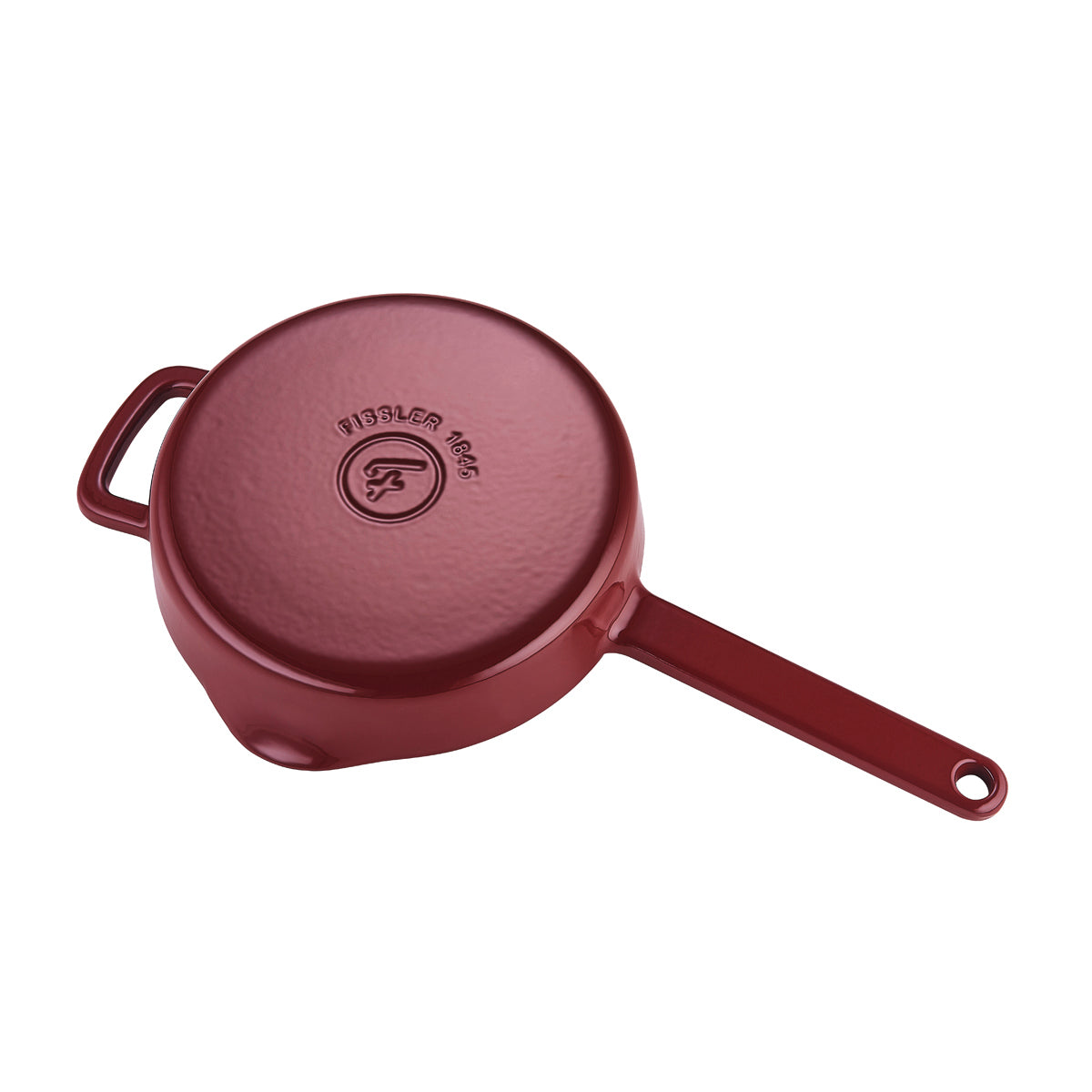 Die umgedrehte rote Fissler Moments Gusseisen Pfanne mit strukturiertem Boden, Griffen und geprägtem Logo steht für langlebige, effiziente deutsche Qualität.
